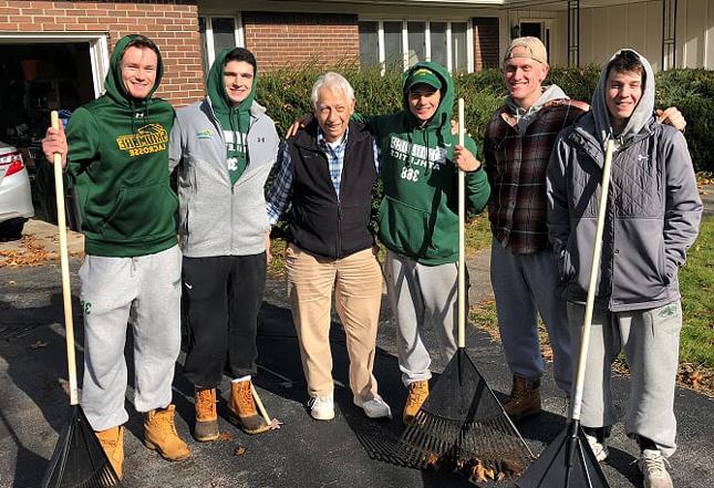 Skidmore students volunteering to rake people's yards