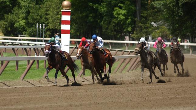 Horses running at a race track